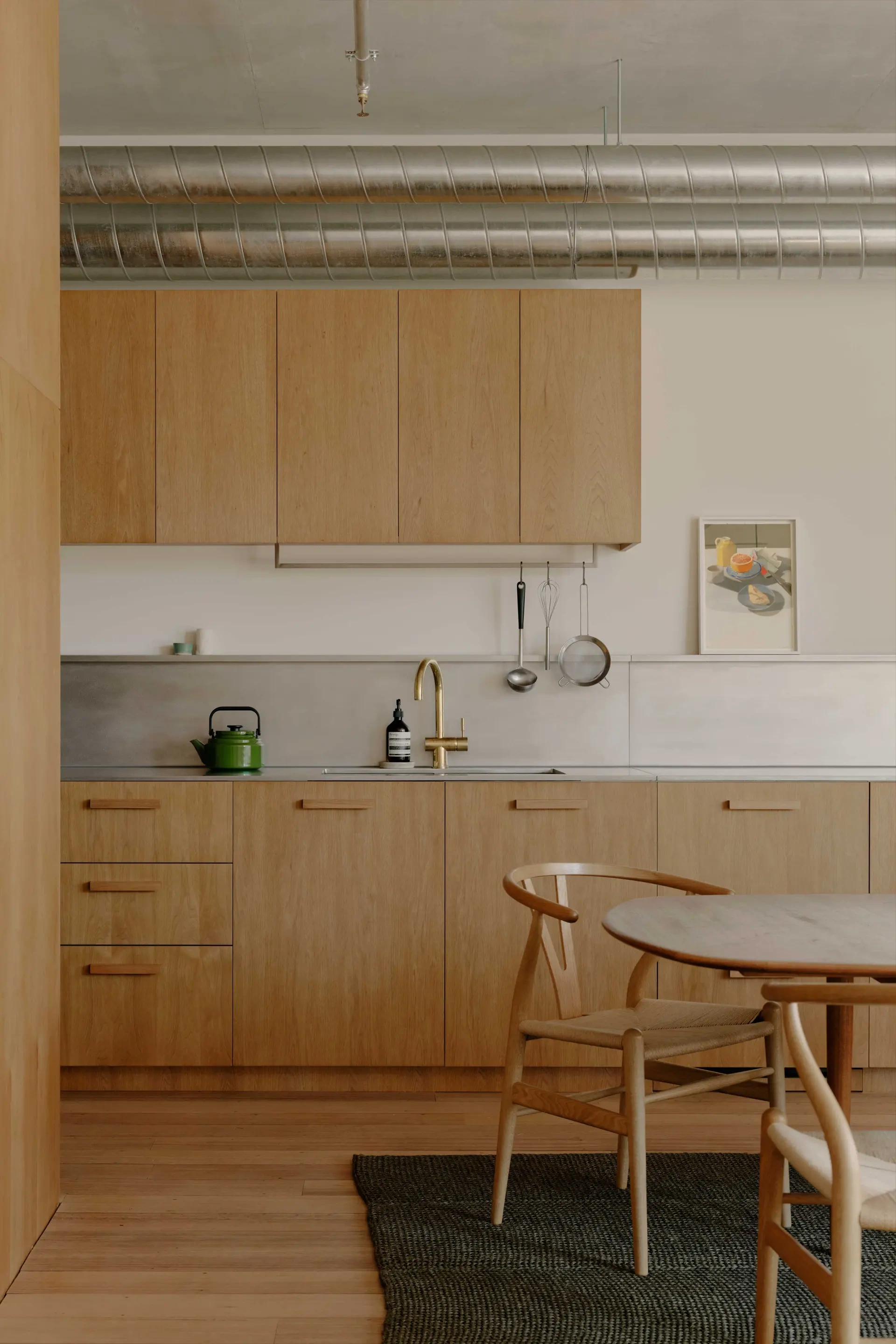 Oak Kitchen with Brass Faucet and Wishbone Chairs
