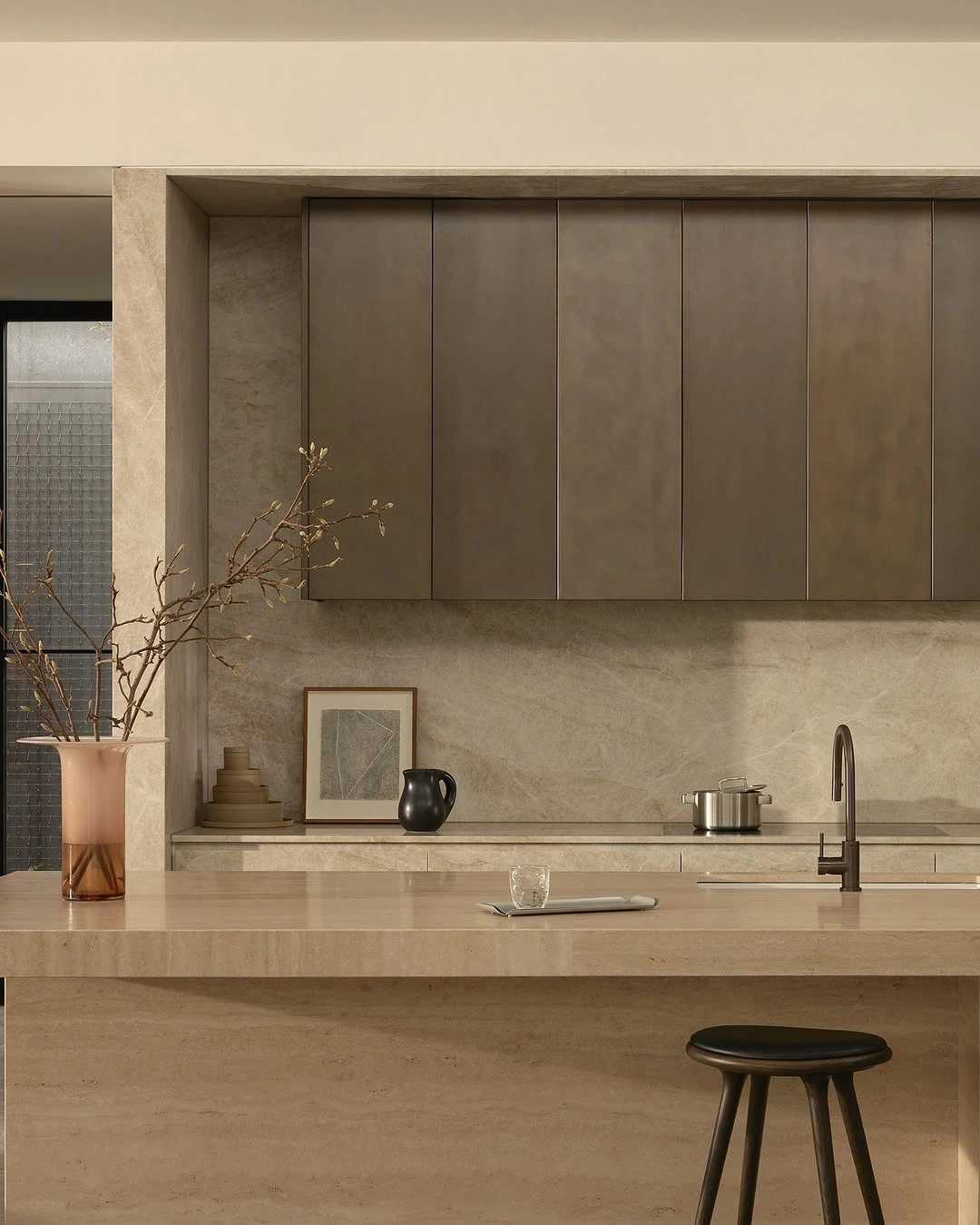 Bronze Cabinetry with Travertine Counter